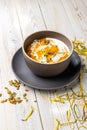 Healthy vegetarian cream soup with pesto sauce and pumpkin seeds, served on white wooden background in rustic style with copy Royalty Free Stock Photo