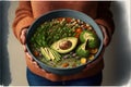 Healthy vegetarian dinner. Woman in jeans and warm sweater holding bowl with fresh salad, avocado, grains, beans, roasted