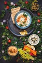 Healthy vegetarian dips and spreads served with fresh vegetables and pita bread