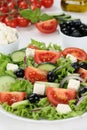Healthy vegetarian eating Greek salad in bowl with tomatoes, Feta cheese and olives Royalty Free Stock Photo