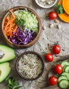 Healthy vegetarian food set background. Cabbage salad, avocado, tomatoes, cucumbers, pumpkin, wild rice on a paper background, top Royalty Free Stock Photo