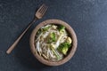 Healthy vegetarian food stir fried Chinese noodles on black stone background Royalty Free Stock Photo