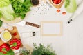 Healthy vegetarian ingredients for spring fresh green salad and kitchenware on white wood board, top view, copy space. Spring vita Royalty Free Stock Photo