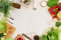 Healthy vegetarian ingredients for spring fresh green salad and kitchenware on white wood board, top view, copy space. Royalty Free Stock Photo