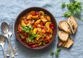 Healthy vegetarian lunch - stewed garden vegetables. Vegetable ratatouille and grilled bread. On a blue background