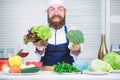 Healthy vegetarian recipe. I choose only healthy ingredients. Man cook hat and apron hold broccoli. Organic vegetables Royalty Free Stock Photo