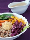 Healthy vegetarian salad with buckwheat porridge, corn, avocado and humus with tahini