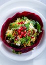 Healthy vegetarian salad, roasted root vegetables, and pomegranate seeds. Fresh mix salad leaves, carrot, and pomegranate seeds. Royalty Free Stock Photo