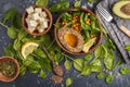 Flat lay of vegetarian salad with tofu, chickpea, avocado and sunflower seeds. Healthy vegan food concept. Dark background, top v Royalty Free Stock Photo