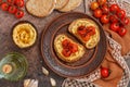 Healthy vegetarian sandwiches with whole grain bread, hummus, baked tomatoes and spices Royalty Free Stock Photo