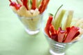 Healthy vegetarian snack for kids. Fresh vegetable sticks from red and green peppers, and cucumber in the glasses.