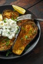 Healthy vegeterain Oven baked aubergines, Eggplant with cottage cheese dip, parsley and lemon wedge.