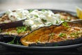 Healthy vegeterain Oven baked aubergines, Eggplant with cottage cheese dip, parsley and lemon wedge.