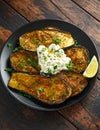 Healthy vegeterain Oven baked aubergines, Eggplant with cottage cheese dip, parsley and lemon wedge.