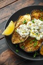 Healthy vegeterain Oven baked aubergines, Eggplant with cottage cheese dip, parsley and lemon wedge.