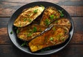 Healthy vegeterain Oven baked aubergines, Eggplant with parsley and herbs in a black plate Royalty Free Stock Photo