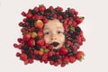 Healthy vitamins fruits. Berries with kids face close-up. Top view of child face with berri. Berry set near kids face
