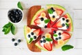 Summer watermelon pizza with blueberries, strawberries, bananas and yogurt, top view table scene against white wood Royalty Free Stock Photo