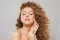 Healthy wavy hair woman portrait. Young fashion model with long curly hairstyle and natural fresh clear skin posing on white Royalty Free Stock Photo