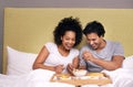 The healthy way to wake up. A cute couple sharing breakfast in bed. Royalty Free Stock Photo