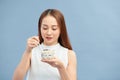 Healthy Weight Loss Food.  Young woman eating yoghurt, raisins and oatmeal Royalty Free Stock Photo