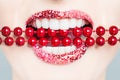 Healthy white teeth, pink lips and red pearls. Royalty Free Stock Photo