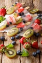 Healthy Whole Fruit Popsicles with Berries Kiwi strawberries closeup on wooden table. vertical Royalty Free Stock Photo