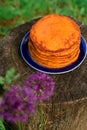 Healthy and wholesome food from pumpkin. Morning breakfast in the fresh air. Pancakes on a blue dish. Royalty Free Stock Photo