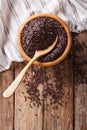 Healthy wild long black rice close up in a wooden bowl and spoon Royalty Free Stock Photo