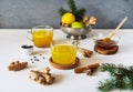 Healthy winter beverage with ginger, turmeric, cinnamon stick, lemon, honey and black pepper. Decorated with pins Royalty Free Stock Photo