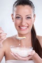 Healthy woman eating cornflakes cereals