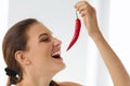 Healthy Woman Eating Spicy Red Chili Pepper. Diet, Food Concept. Royalty Free Stock Photo