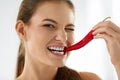 Healthy Woman Eating Spicy Red Chili Pepper. Diet, Food Concept. Royalty Free Stock Photo