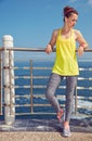 Healthy woman in fitness outfit looking aside at embankment Royalty Free Stock Photo