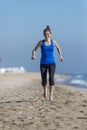 Healthy woman jogger on seashore in evening running Royalty Free Stock Photo