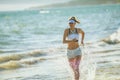 Healthy woman jogger on ocean coast in evening running Royalty Free Stock Photo