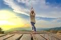 Healthy woman lifestyle balanced practicing meditate and zen energy yoga outdoors on the bridge in morning the mountain nature. Royalty Free Stock Photo