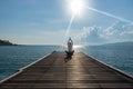 Healthy woman lifestyle exercising vital meditate and practicing yoga at on the bridge seashore, nature background.