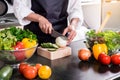 Healthy Woman makes fresh vegetable salad with olive oil, tomato