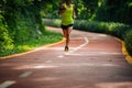 Woman runner running on morning park road workout jogging Royalty Free Stock Photo