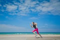 Healthy woman running on the beach, girl doing sport outdoor, happy female exercising, freedom, vacation, fitness and Royalty Free Stock Photo