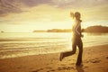 Healthy woman running on the beach at sunset Royalty Free Stock Photo