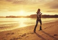 Healthy woman running on the beach at sunset Royalty Free Stock Photo