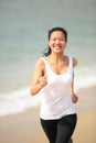 Healthy woman running on beach Royalty Free Stock Photo