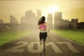 Healthy woman runs on road with 2017