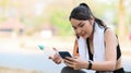 Healthy woman taking a break after exercising session and using smart phone. Royalty Free Stock Photo