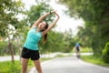 Healthy woman warming up before jogging run and relax stretching her arms Royalty Free Stock Photo