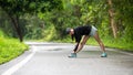 Healthy woman warming up before jogging run and relax stretching her arms and looking away in the road Royalty Free Stock Photo