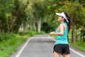 Healthy woman warming up in the road outdoor. Asian runner woman workout before fitness and jogging session at the park