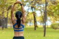 Healthy woman warming up stretching her arms. Asian runner woman workout before fitness and jogging session at the park.